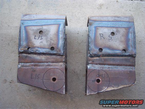 Two welded metal brackets, one labeled L/S and the other R/S, with circles and crosshairs drawn on the bottom sections
