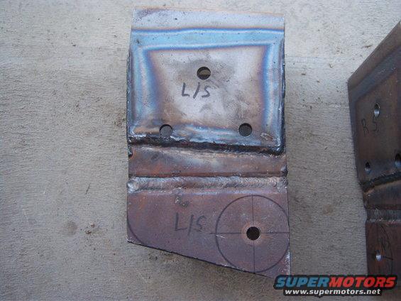 Welded metal bracket with 'L/S' marked on it, showing drill holes and scribe lines