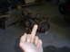 1992 Ford Bronco - Two rusty front axle assemblies are shown, with a hand obscuring part of the view and giving the middle finger.