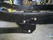 1992 Ford Bronco - Close-up view of vehicle frame rails and a bolted bracket.