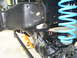 1992 Ford Bronco - The image shows a close-up of a vehicle's suspension system, including a bright blue coil spring and various metal components.