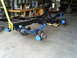 1992 Ford Bronco - A vehicle frame and suspension system are shown, with blue-painted parts and disc brakes visible.