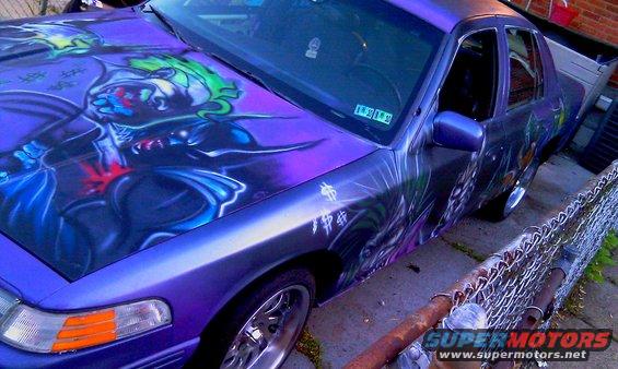 1995 Ford Crown Victoria with custom Joker airbrushing on hood and doors, purple paint, chrome wheels