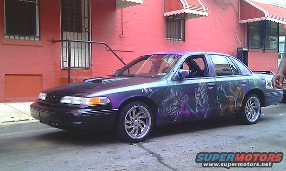 Purple sedan with custom airbrushed graphics, hood scoop, and aftermarket wheels