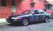 1995 Ford Crown Victoria - This 1995 Ford Crown Victoria features a custom purple and green airbrushed design with a hood scoop and chrome wheels.