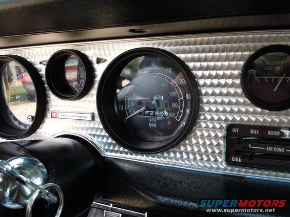 Dashboard with speedometer, tachometer, fuel gauge, and climate controls. Speedometer shows 28243 miles