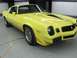 1976 Pontiac Trans Am - This yellow 1977 Pontiac Firebird features distinctive racing stripes on its hood and body.