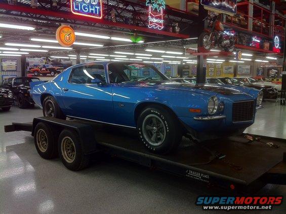 Blue muscle car on trailer, 1970s body style