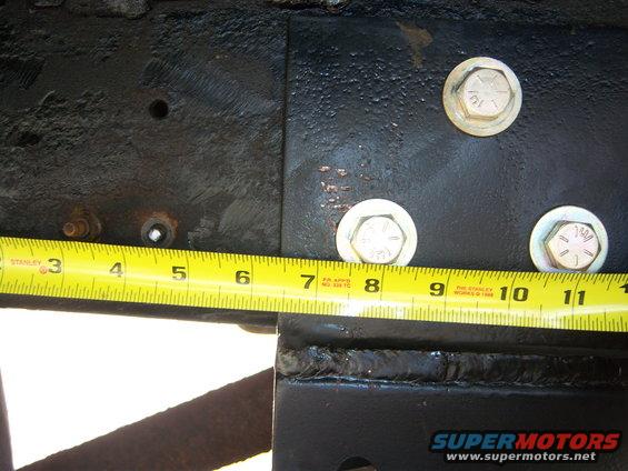 Measuring frame section with tape measure showing 8 inches
