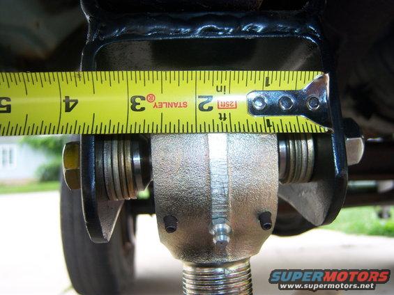 Tape measure showing approximately 3.5 inches on a vehicle suspension component