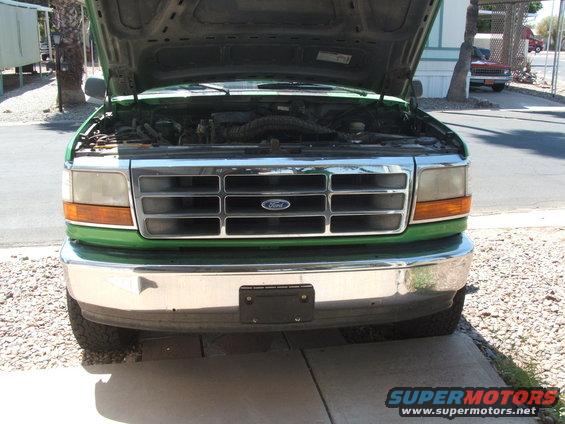 Green 1995 Ford Bronco front view with hood open