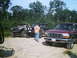 1988 Ford Bronco - Maroon Ford F-150 front end visible with two other SUVs behind it.