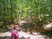 1988 Ford Bronco - A man stands by a wooded trail during an outdoor excursion.