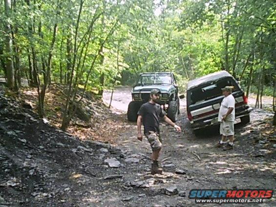 1988 Ford Bronco and another SUV on a dirt path