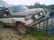 1988 Ford Bronco - This 1987 Ford Bronco is covered in mud and positioned on a blue ramp, suggesting off-road use.