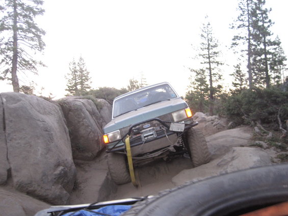 1989 Ford Bronco off-roading on a rocky trail, front winch visible