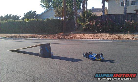 Blue remote control car flipped on its side