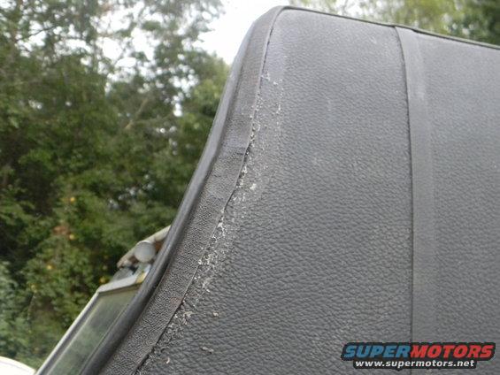 Close-up of the worn edge of a black vinyl vehicle top