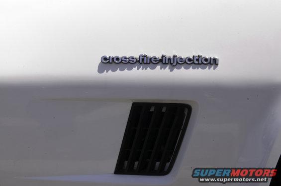 White car fender with "cross-fire injection" badge and black vent