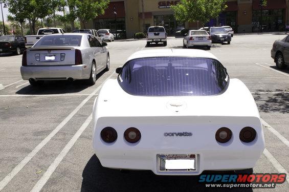 White Corvette rear view with California plates and 'Corvette' badging