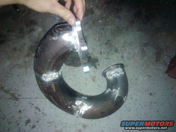 Custom bent metal exhaust pipe with welded flanges