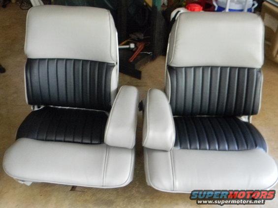 Two bucket car seats with light gray outer sections and black pleated inserts