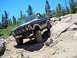 1986 Ford Bronco - This 1986 Ford Bronco tackles a challenging off-road trail with steep inclines and large rocks.