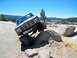 1986 Ford Bronco - This modified Ford Bronco navigates a rocky obstacle course under a clear blue sky.