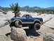1986 Ford Bronco - This 1986 Ford Bronco is shown off-roading through a challenging rocky landscape.
