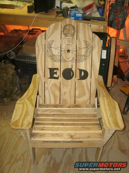Wooden chair with EOD insignia and text on the back and seat