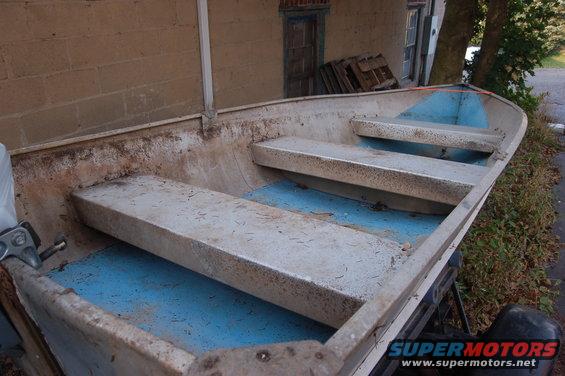 Aluminum boat interior with blue floor and three bench seats