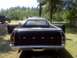 1979 Ford Ranchero - This 1979 Ford Ranchero is seen from the rear with its doors open, parked outdoors next to another truck.