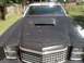 1979 Ford Ranchero - Front view of a dark pickup truck with a hood scoop and visible rust on the roof.