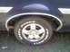1979 Ford Ranchero - Close-up view of a vehicle's wheel and fender, showing chrome trim and tire lettering.