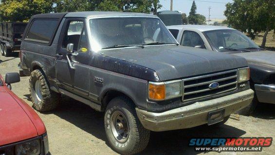 1989 Ford Bronco parked outdoors next to other vehicles