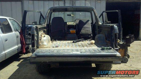Rear view of a 1989 Ford Bronco with doors open and interior exposed