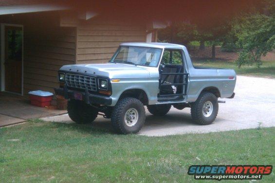 Silver 1978 Ford Bronco with off-road tires and removed doors