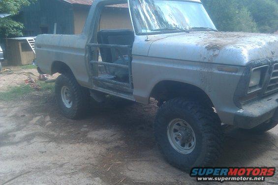 1978 Ford Bronco with roll cage, doors removed, parked outdoors