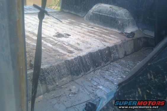 Muddy truck bed interior with a floor shifter