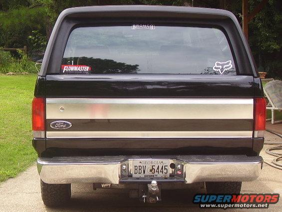 Black 1988 Ford Bronco rear view with Flowmaster and Fox Racing stickers on the window