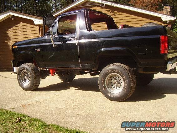 Black 1986 Ford Bronco, 3q front view. "Bronco" badge visible