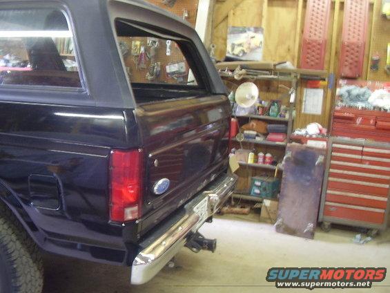 Black Ford Bronco rear quarter panel and bumper in a garage