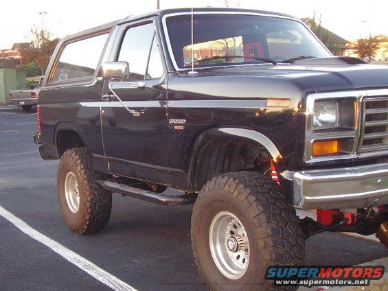 Black 1986 Ford Bronco with lifted suspension and chrome wheels