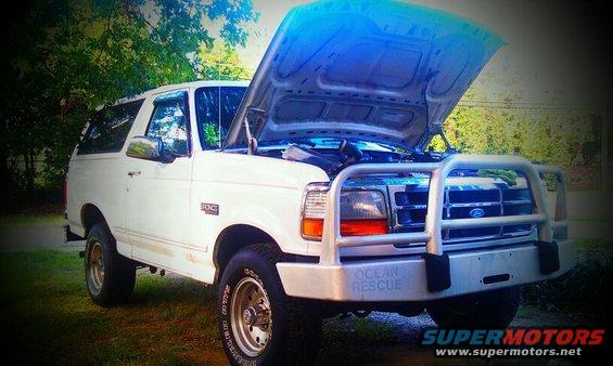 White 1996 Ford Bronco, front quarter view, hood open, with a brush guard and "OCEAN RESCUE" text on the bumper