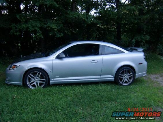 Silver 2009 Chevrolet Cobalt coupe parked on grass with trees in background