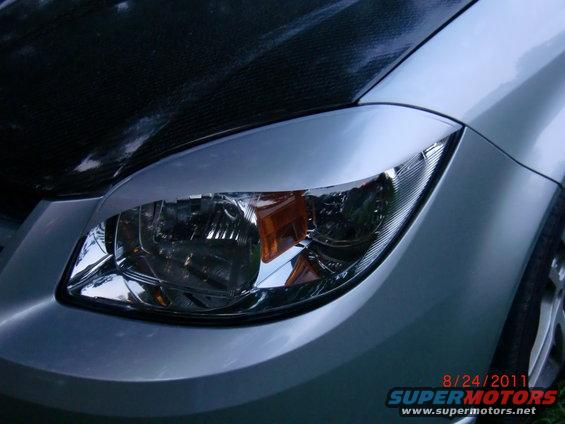 Silver 2009 Chevrolet Cobalt front passenger side headlight and carbon fiber hood