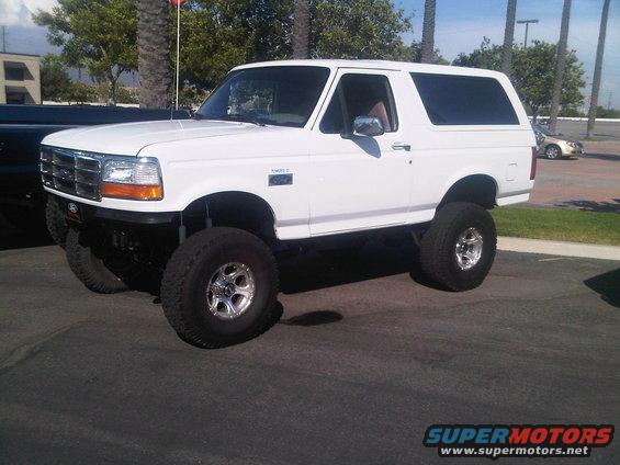 White lifted Ford Bronco with aftermarket wheels and tires