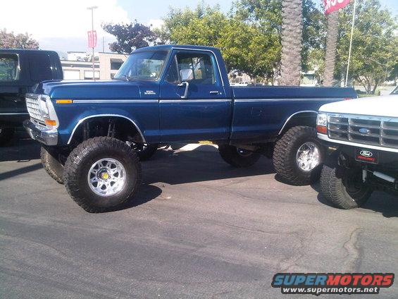Lifted blue 1979 Ford F-150 pickup truck with large off-road tires