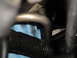 2003 Ford Taurus - A close-up view of automotive AC lines and hoses, with a mechanic's blue gloves visible.