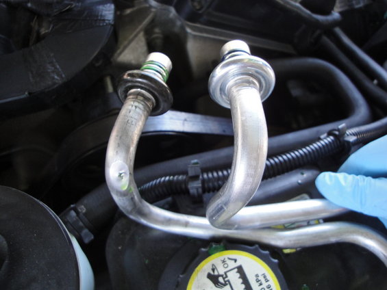 AC lines with green and white fittings, close-up view